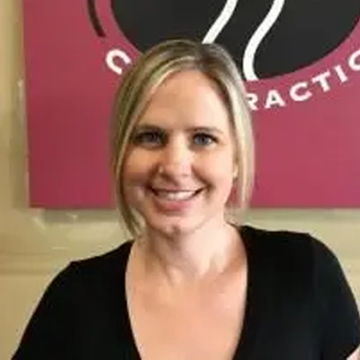 Christina Grange smiling in a black shirt.