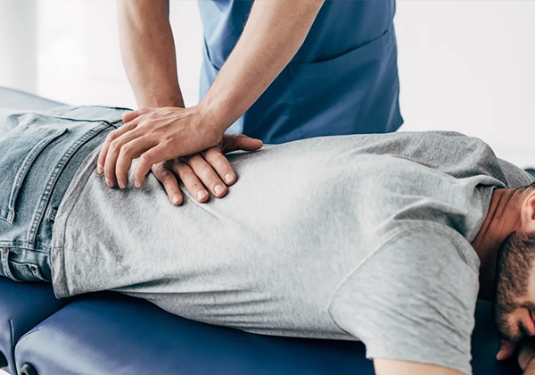 A chiropractor performing a back adjustment.