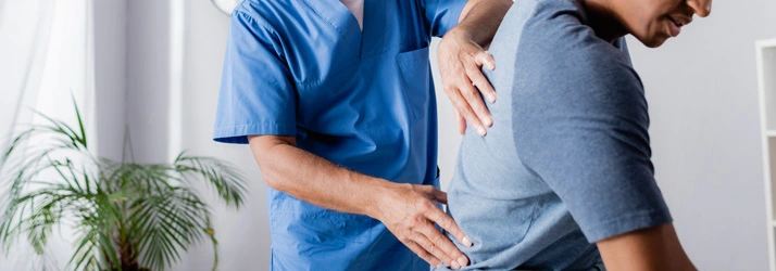 A chiropractor giving a back exam.